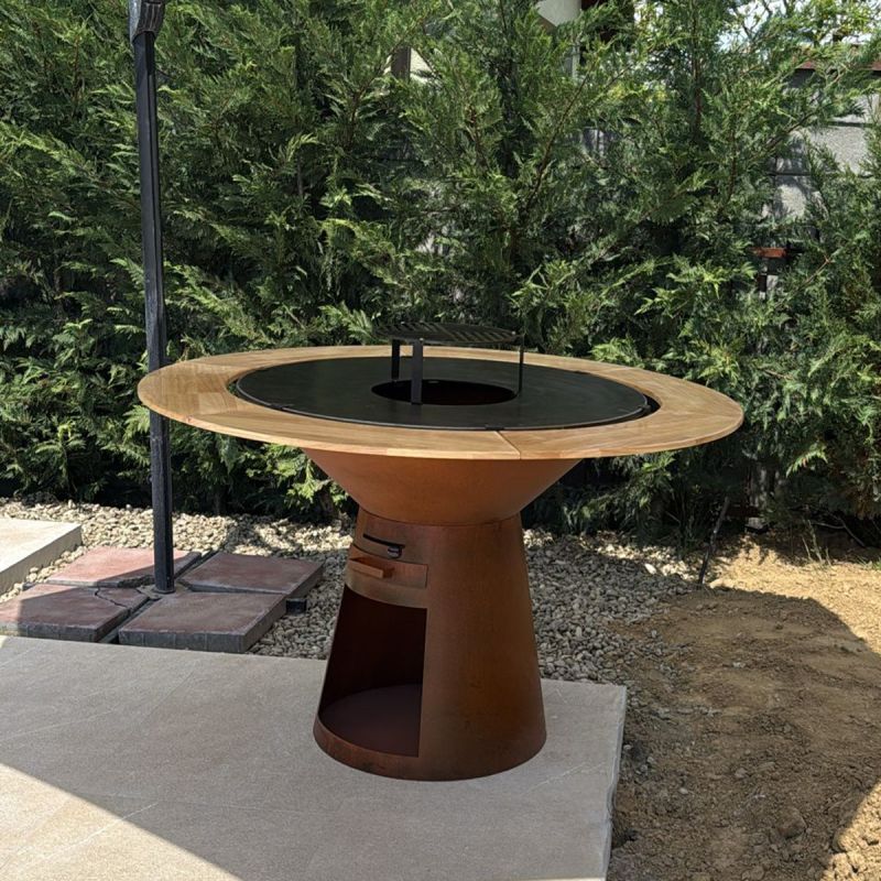 Gratar pe lemn cu plita mare din fonta si blat din lemn, spatiu depozitare lemne, otel corten, dia 100xH 90 cm, Avangarde